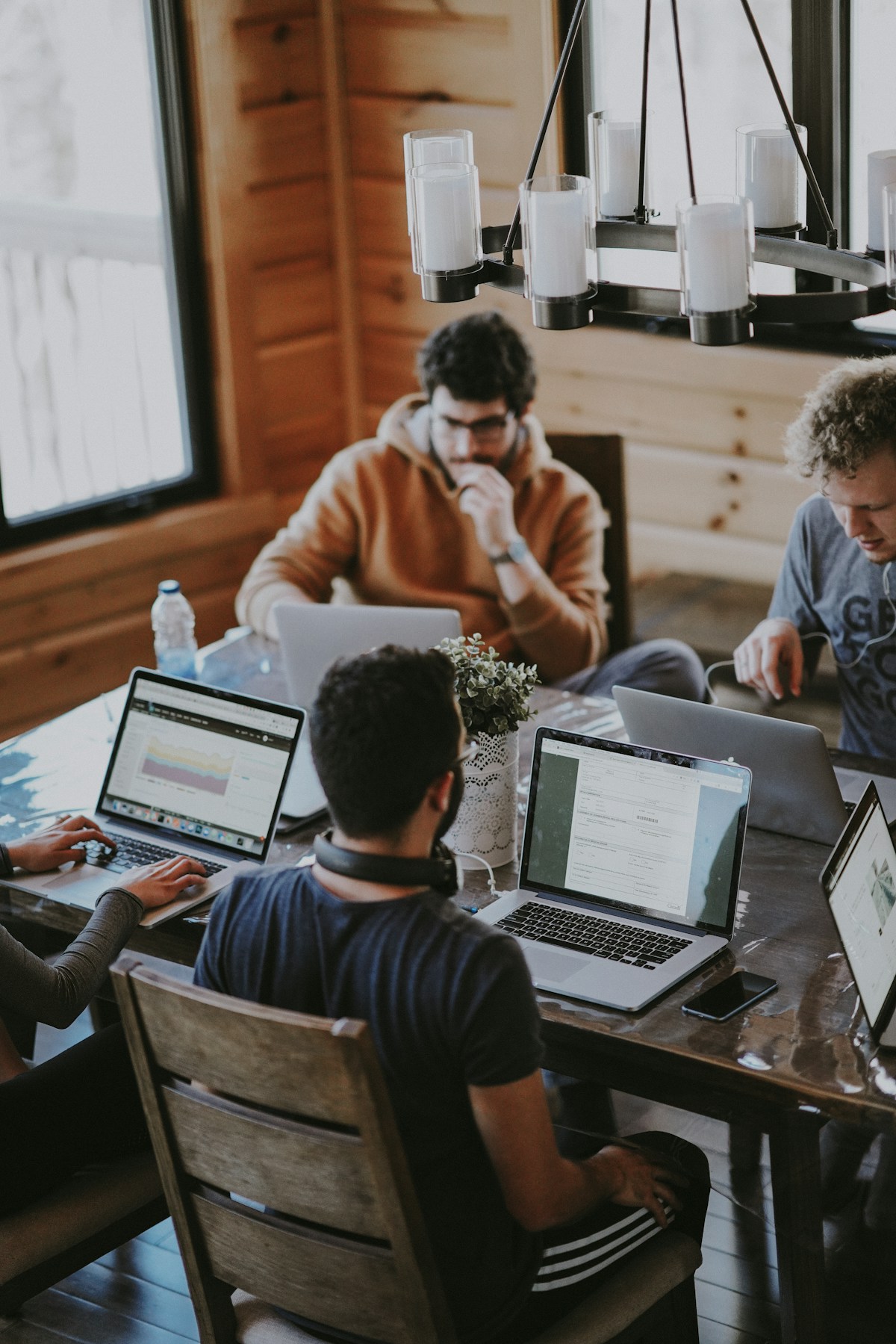 Compliance and risk professionals collaborating around a laptop